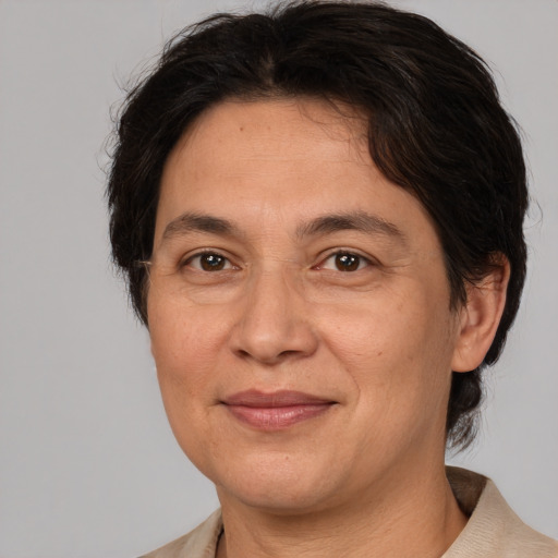 Joyful white adult female with medium  brown hair and brown eyes