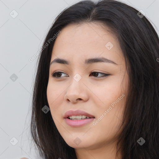 Joyful asian young-adult female with long  brown hair and brown eyes