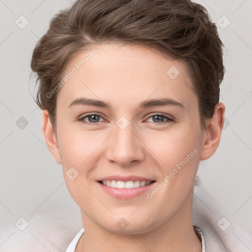 Joyful white young-adult female with short  brown hair and grey eyes