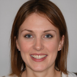 Joyful white young-adult female with medium  brown hair and blue eyes