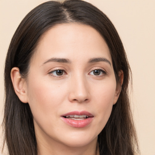 Joyful white young-adult female with long  brown hair and brown eyes