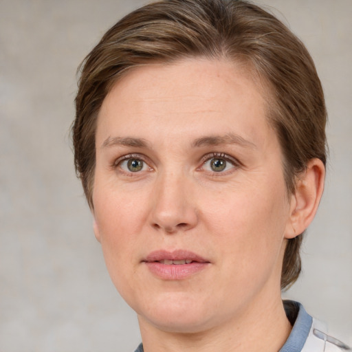 Joyful white adult female with medium  brown hair and green eyes