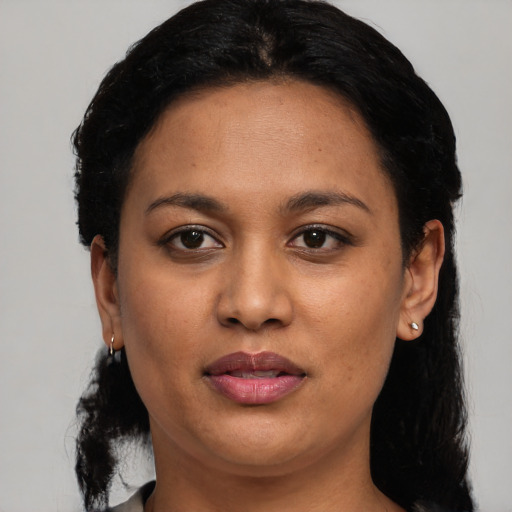 Joyful latino young-adult female with medium  black hair and brown eyes