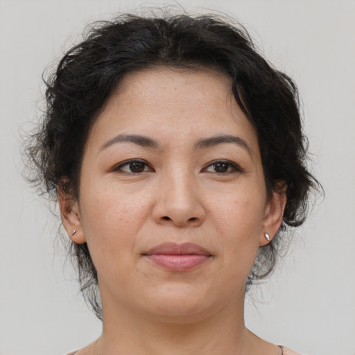 Joyful asian adult female with medium  brown hair and brown eyes