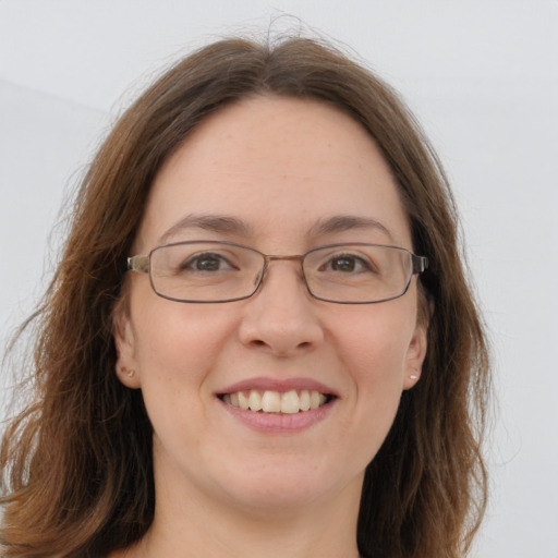 Joyful white young-adult female with long  brown hair and green eyes