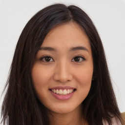 Joyful asian young-adult female with long  brown hair and brown eyes