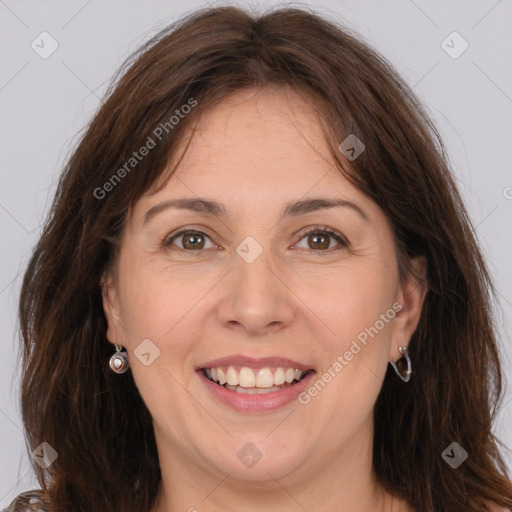 Joyful white adult female with long  brown hair and brown eyes