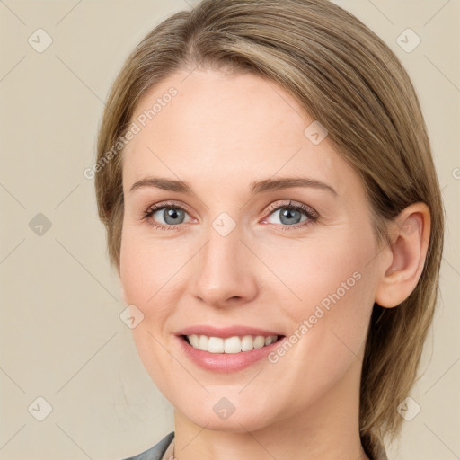 Joyful white young-adult female with medium  brown hair and grey eyes