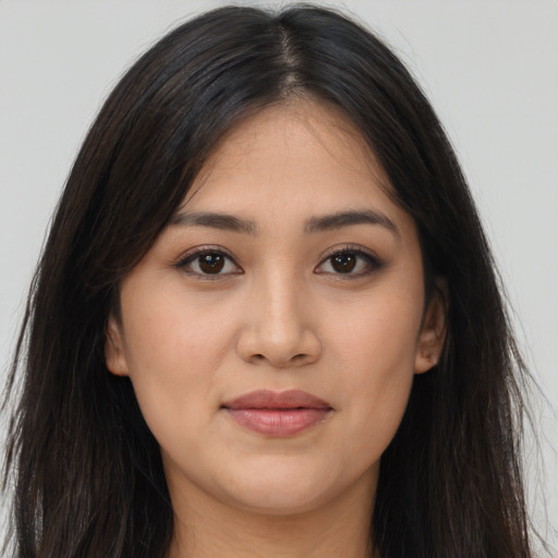Joyful latino young-adult female with long  brown hair and brown eyes