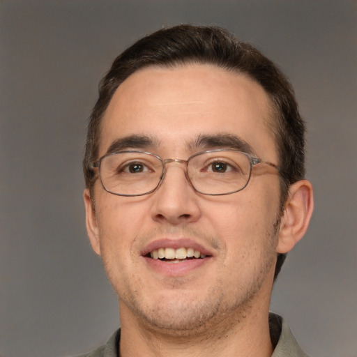 Joyful white adult male with short  brown hair and brown eyes