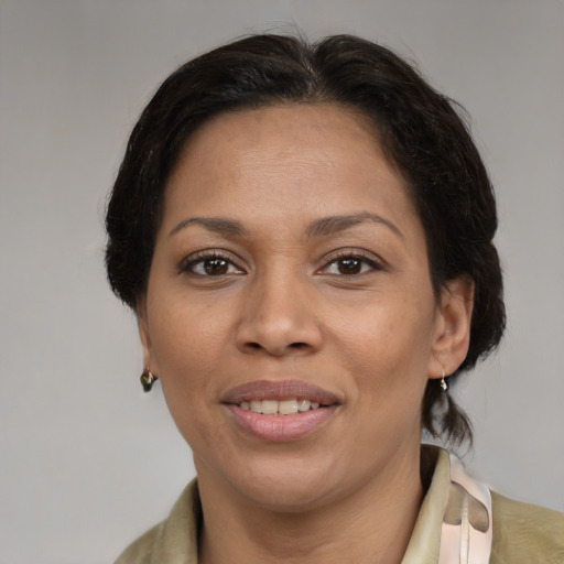 Joyful latino adult female with medium  brown hair and brown eyes