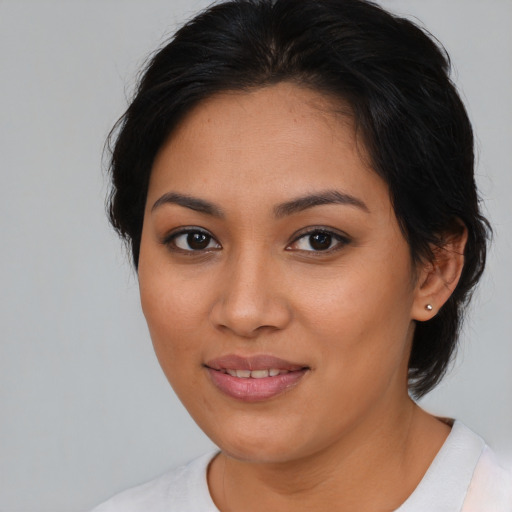 Joyful latino young-adult female with medium  brown hair and brown eyes