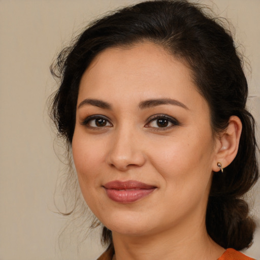 Joyful latino young-adult female with medium  brown hair and brown eyes
