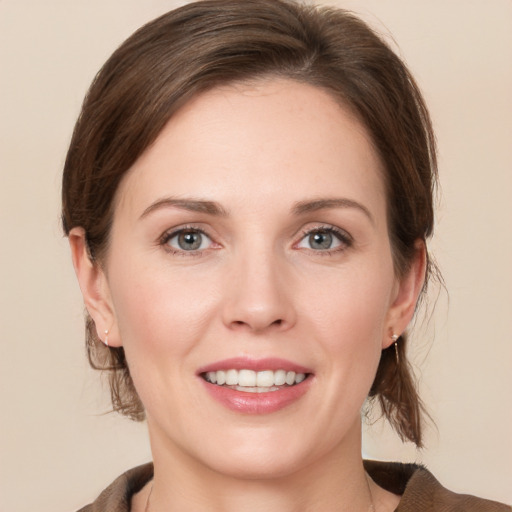 Joyful white young-adult female with medium  brown hair and grey eyes