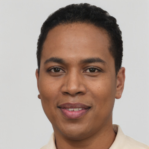 Joyful black young-adult male with short  black hair and brown eyes
