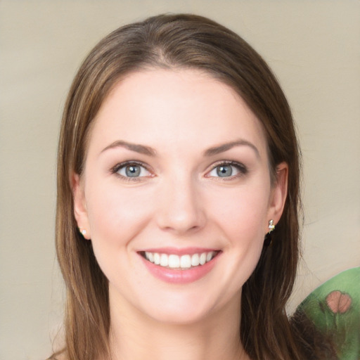 Joyful white young-adult female with long  brown hair and green eyes