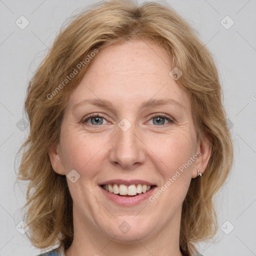 Joyful white adult female with medium  brown hair and blue eyes