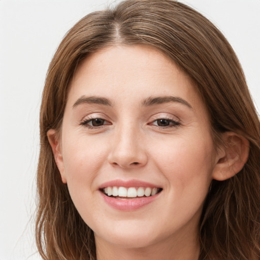 Joyful white young-adult female with long  brown hair and green eyes