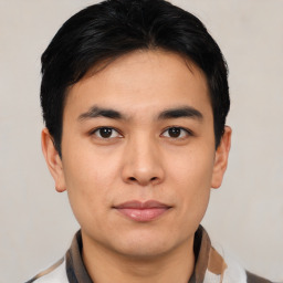 Joyful asian young-adult male with short  black hair and brown eyes