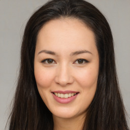 Joyful asian young-adult female with long  brown hair and brown eyes