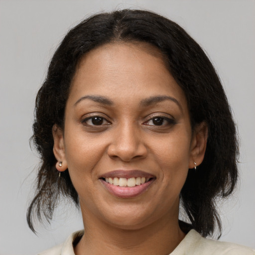 Joyful black young-adult female with medium  brown hair and brown eyes