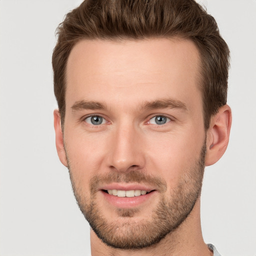 Joyful white young-adult male with short  brown hair and grey eyes