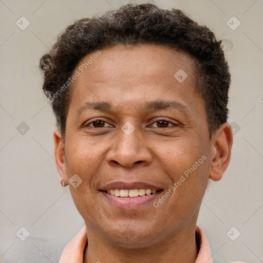 Joyful latino adult male with short  brown hair and brown eyes