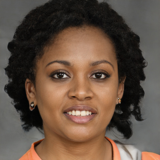 Joyful black young-adult female with medium  brown hair and brown eyes