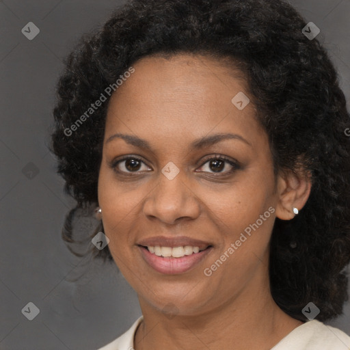 Joyful black young-adult female with long  brown hair and brown eyes