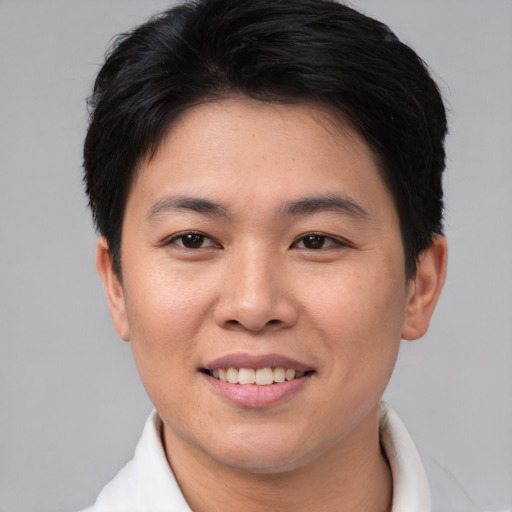 Joyful asian young-adult female with short  black hair and brown eyes