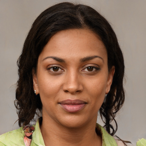Joyful black young-adult female with medium  brown hair and brown eyes