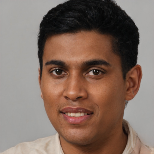 Joyful latino young-adult male with short  black hair and brown eyes