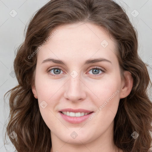 Joyful white young-adult female with long  brown hair and blue eyes