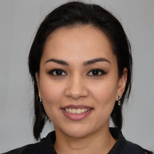 Joyful white young-adult female with medium  black hair and brown eyes