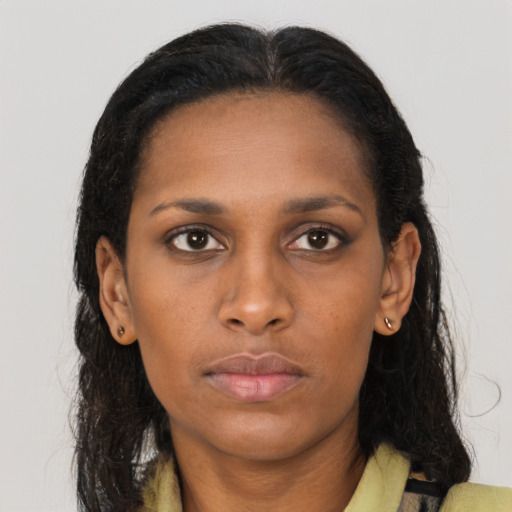 Neutral black young-adult female with long  brown hair and brown eyes