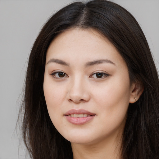 Joyful asian young-adult female with long  brown hair and brown eyes