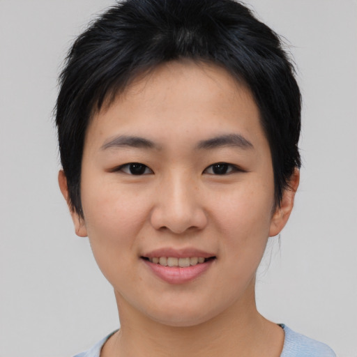 Joyful asian young-adult female with short  brown hair and brown eyes