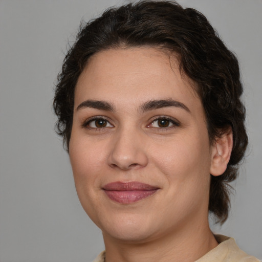 Joyful white young-adult female with medium  brown hair and brown eyes