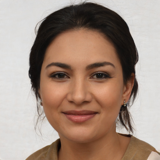 Joyful latino young-adult female with medium  brown hair and brown eyes