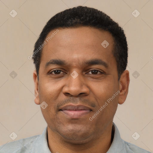 Joyful latino adult male with short  black hair and brown eyes