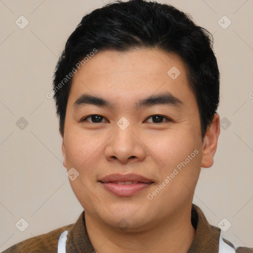 Joyful asian young-adult male with short  brown hair and brown eyes