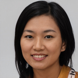 Joyful asian young-adult female with medium  black hair and brown eyes