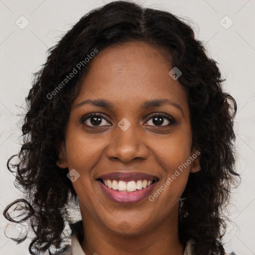 Joyful black young-adult female with long  brown hair and brown eyes