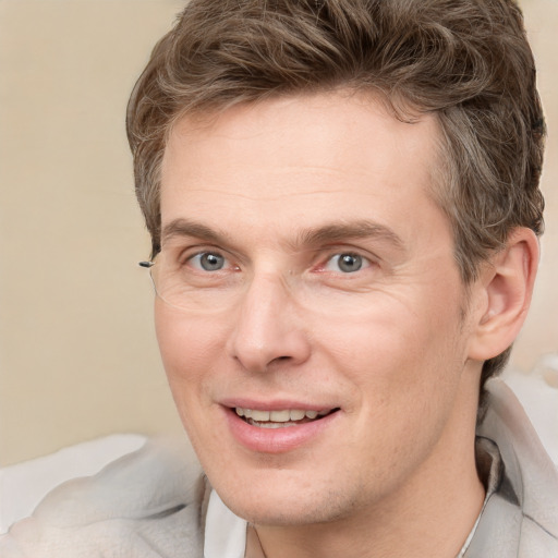 Joyful white adult male with short  brown hair and grey eyes