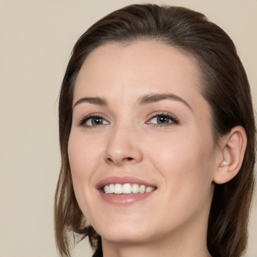 Joyful white young-adult female with medium  brown hair and brown eyes