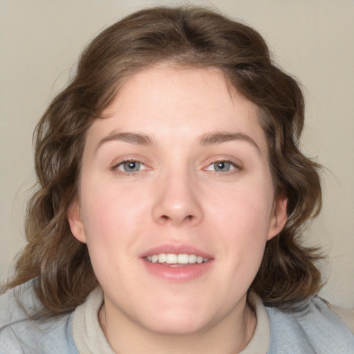 Joyful white young-adult female with medium  brown hair and blue eyes