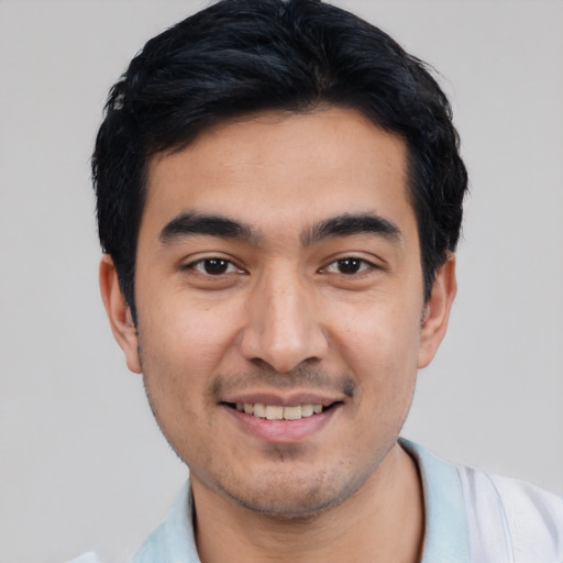 Joyful white young-adult male with short  black hair and brown eyes