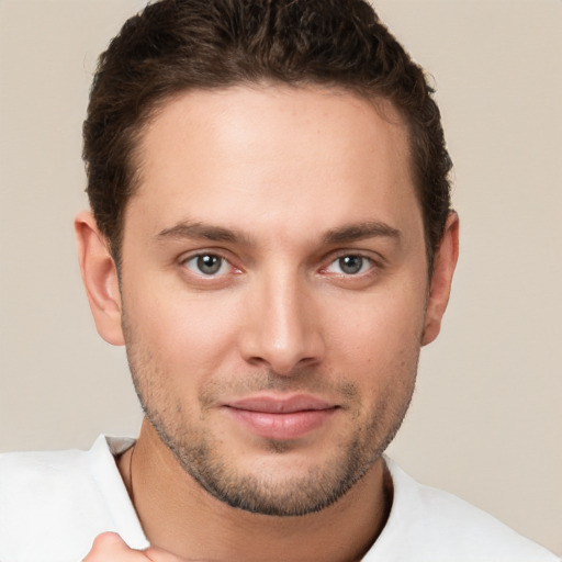 Joyful white young-adult male with short  brown hair and brown eyes