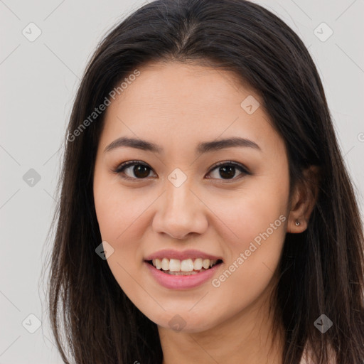 Joyful asian young-adult female with long  brown hair and brown eyes