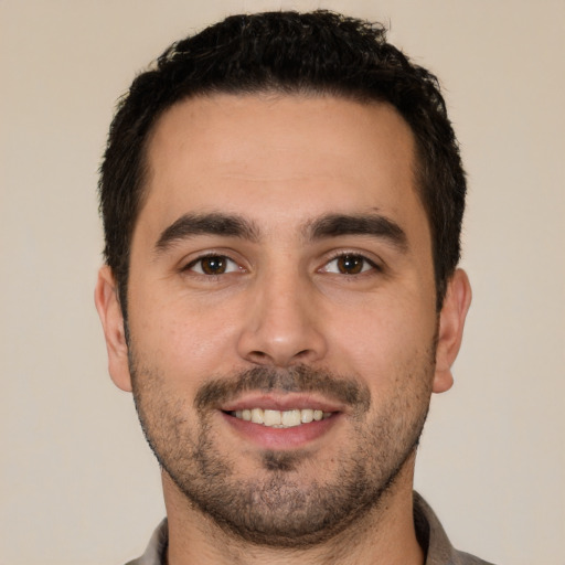 Joyful white young-adult male with short  black hair and brown eyes